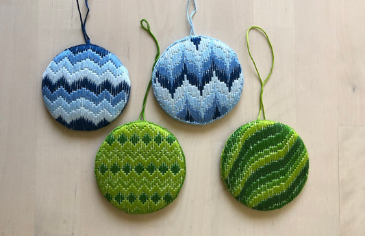 four bargello Christmas ornaments.