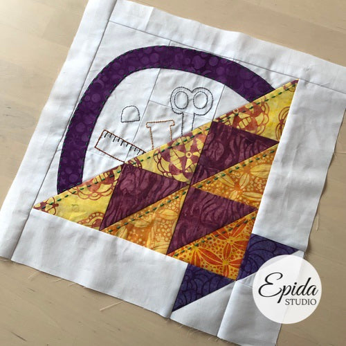 traditional quilt block embellished with embroidery.