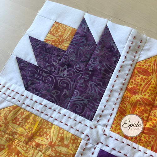 close up of quilt block with hand embroidery.
