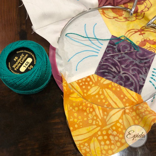 embroidering on bow tie quilt block.