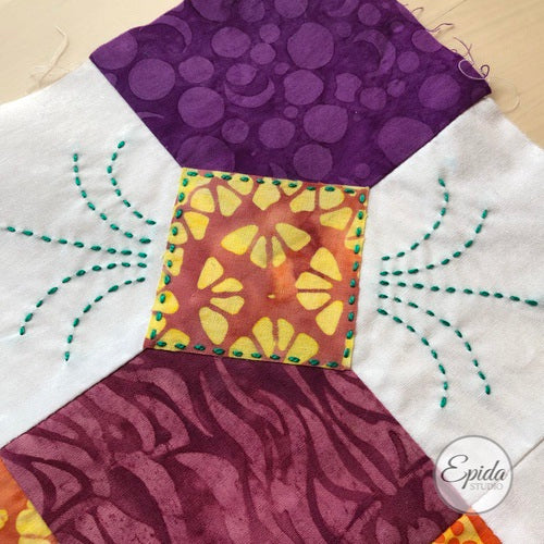 close up of embroidery on quilt block.