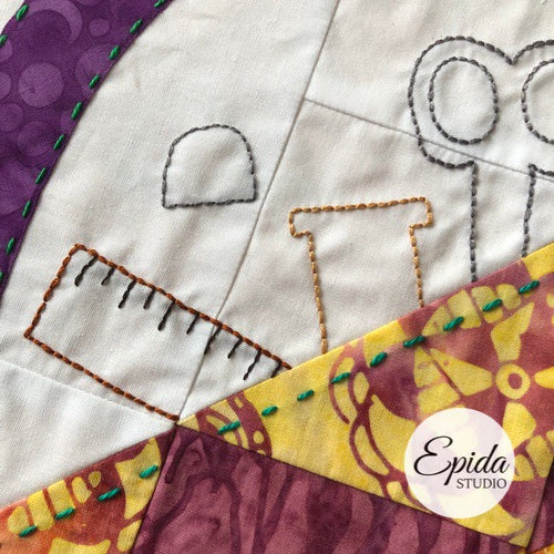 close up of embroidery on quilt block.