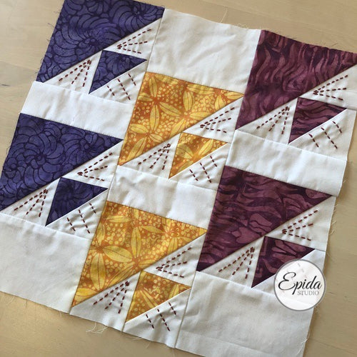 traditional quilt block with hand embroidery.