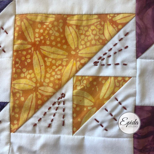close up of birds in air quilt block with embroidery.