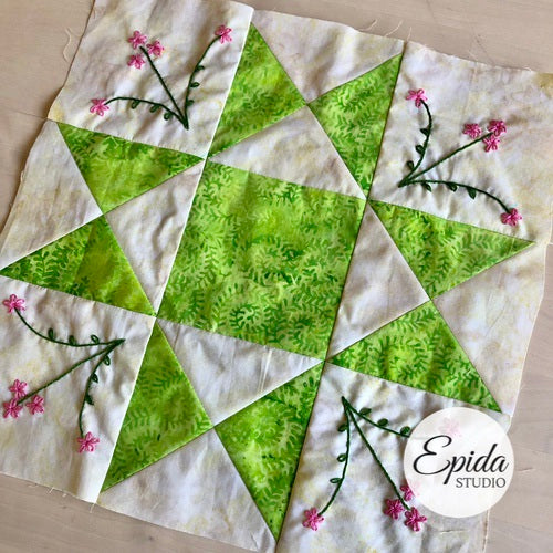 quilt block embellished with hand embroidery.