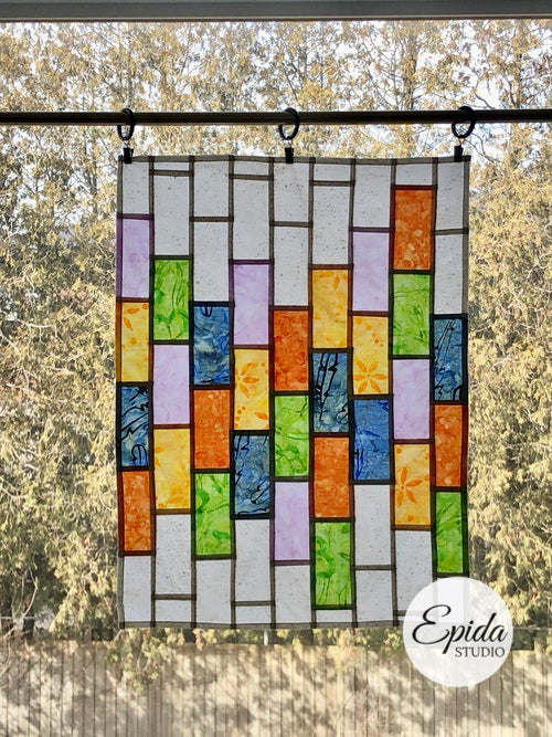 stained glass window hanging in pastel colours.