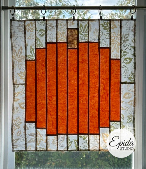 Pumpkin design stained glass window hanging.