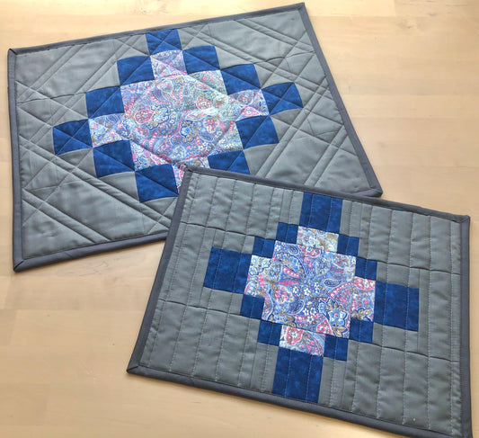 two grey and blue placemats.