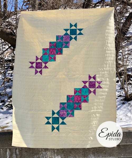 white quilt with teal and purple ohio stars.