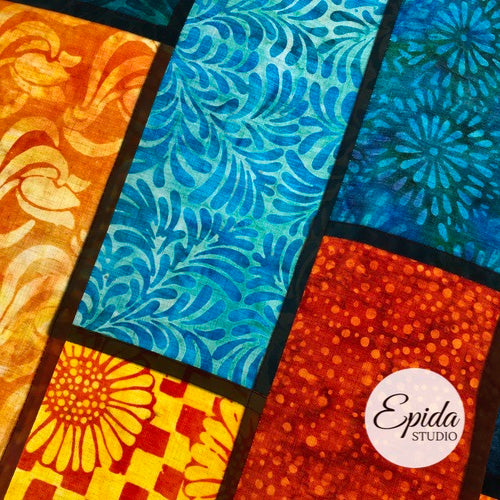 close up of pojagi seams on teal and gold pojagi window hanging.