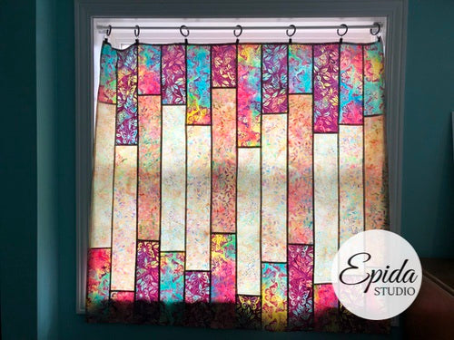 Multicolor floral stained glass window hanging in a window.