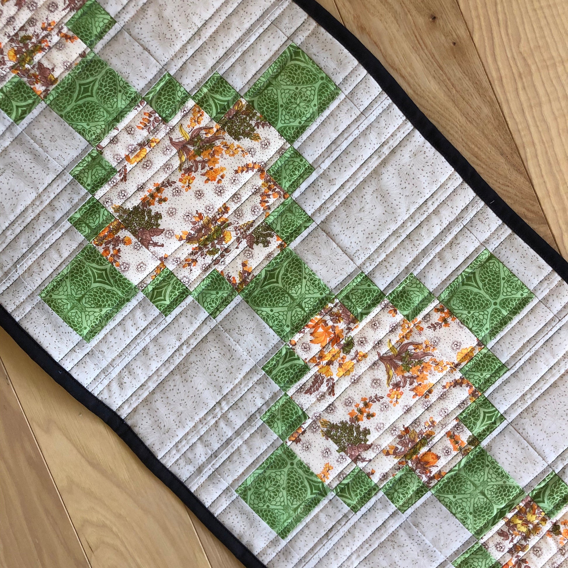 close up of table runner with straight line quilting.