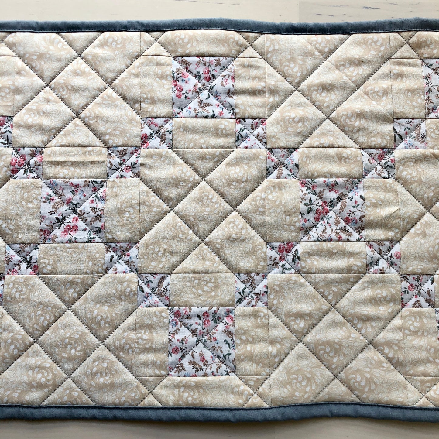 close up of diagonal line quilting on table runner.