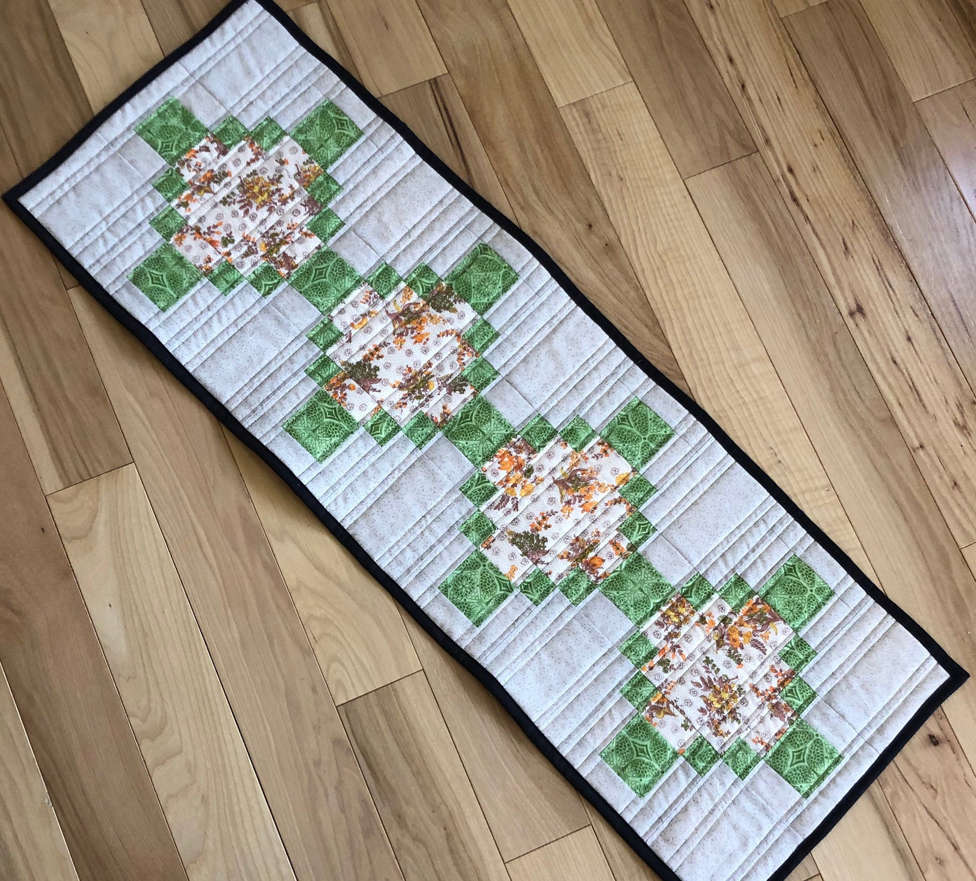 table runner with green accent fabric.