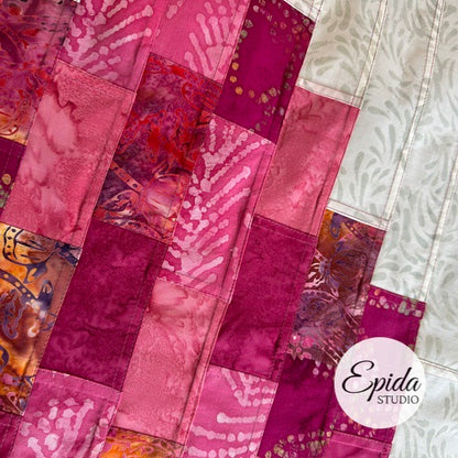Patchwork fabric with pink and purple patterns, featuring the Epida Studio logo.