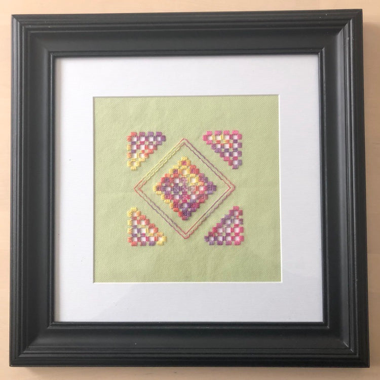 hardanger embroidery in a frame.