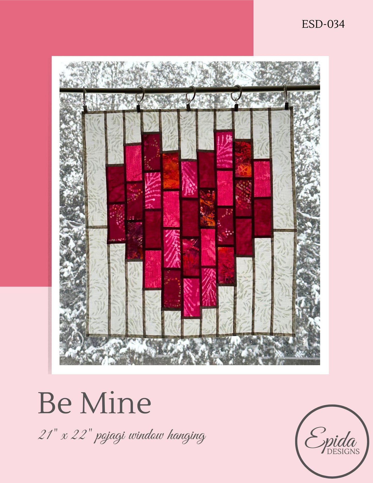 Heart-shaped stained glass window hanging with pink and red colors on a white background, featuring the brand 'Epida Designs'.