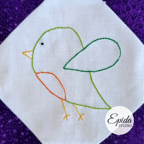 Embroidered bird design on fabric with 'Epida Studio' logo.