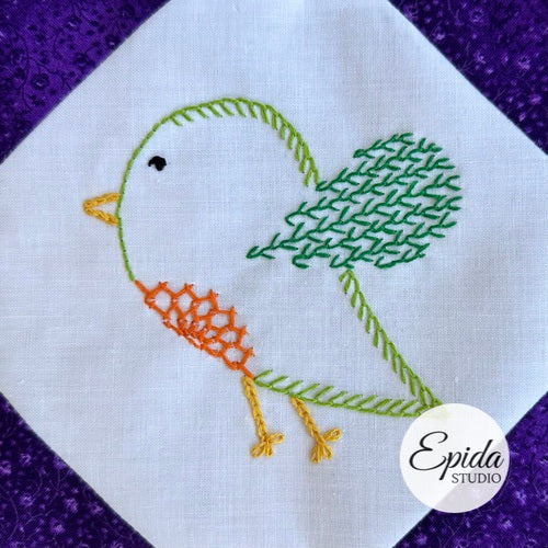 Embroidered bird design on fabric with 'Epida Studio' logo.