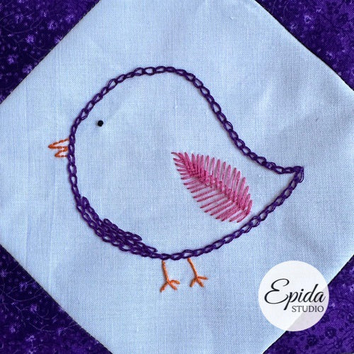 Embroidered bird design on fabric with 'Epida Studio' logo.