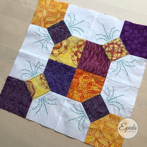purple and gold bow tie quilt block with embroidery.