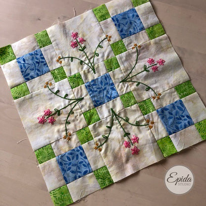 double nine patch quilt block with hand embroidery.