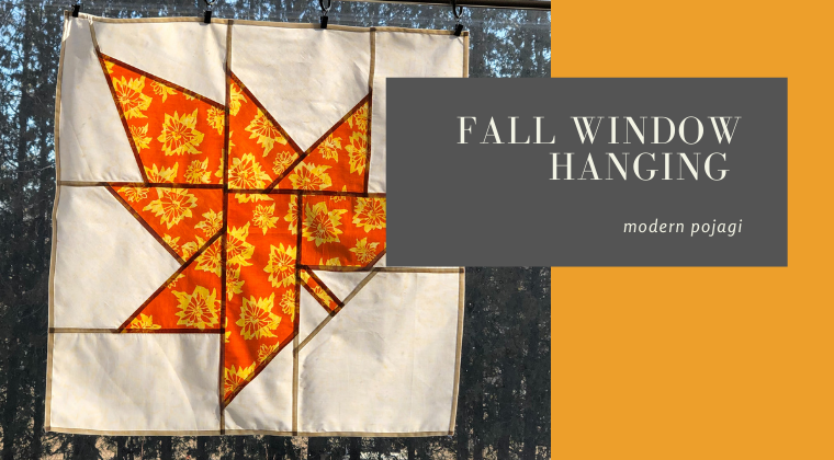 patchwork orange maple leaf hanging in window with title "Fall window hanging".