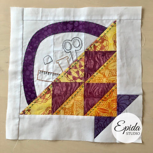 basket quilt block with embroidered sewing tools.