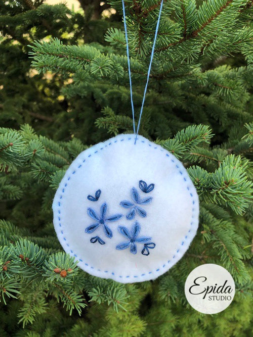 white Christmas ornament with blue flowers.
