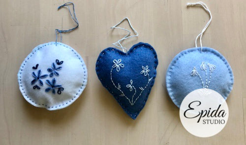 three hand embroidered ornaments.