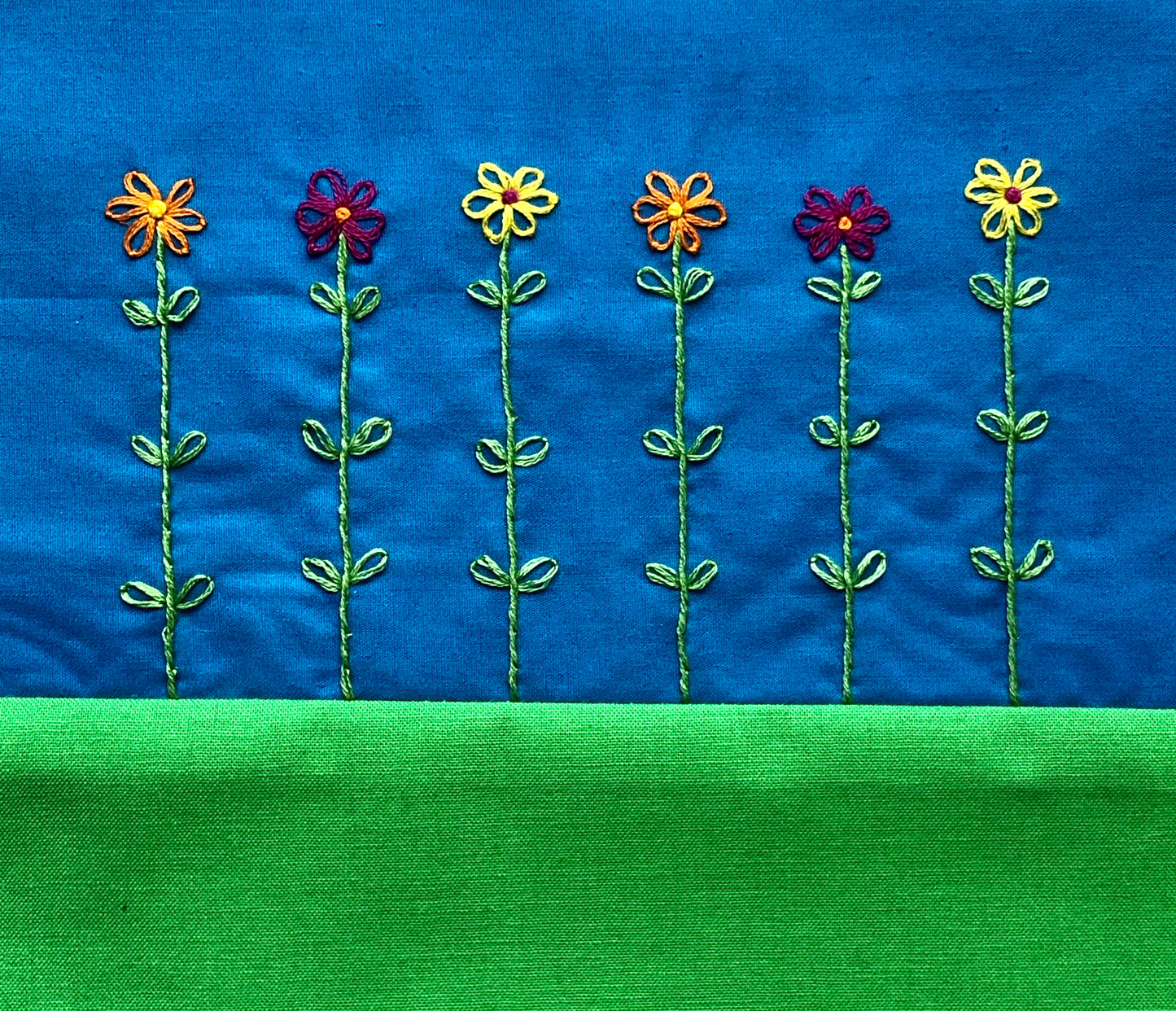 hand stitched lazy daisy flowers.