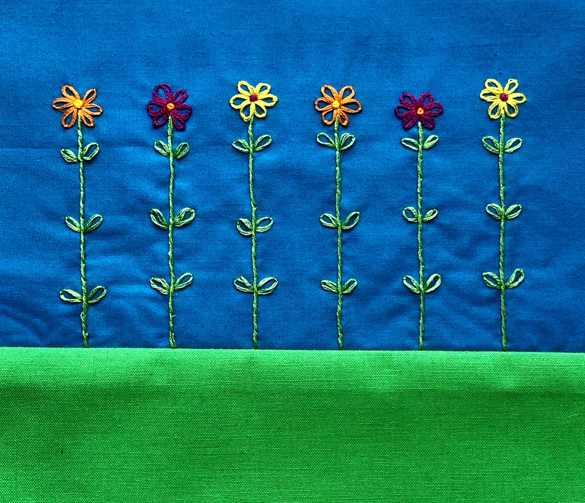 hand stitched lazy daisy flowers.