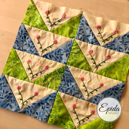 flying geese quilt block with embroidery.