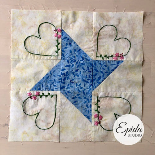 hand embroidered friendship star quilt block.