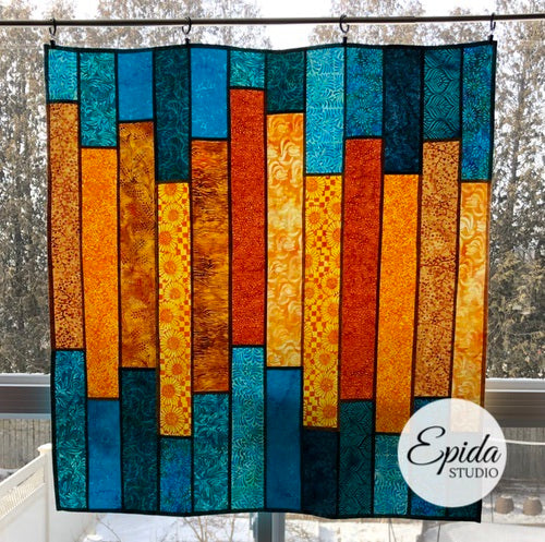 Teal and gold "Glimmer" stained glass window hanging.