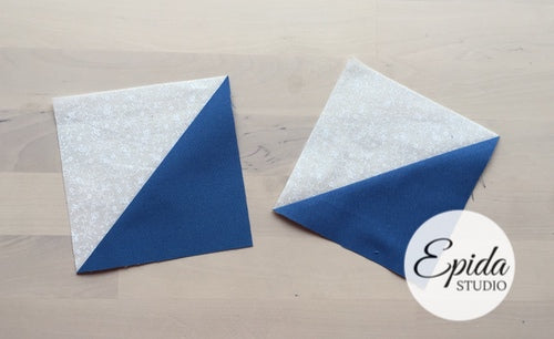 Two fabric blocks with a diagonal split of white glitter and blue fabric, arranged on a light wood background with an Epida Studio logo overlay.