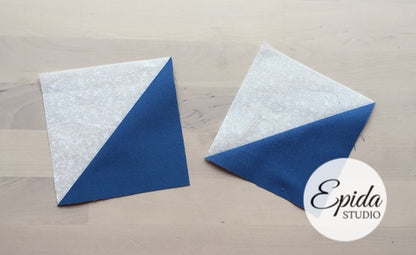 Two fabric blocks with a diagonal split of white glitter and blue fabric, arranged on a light wood background with an Epida Studio logo overlay.