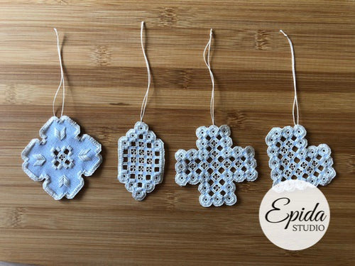 four hardanger stitched ornaments.