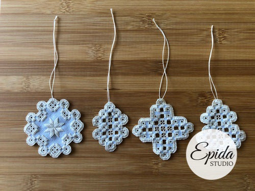 four hand-stitched hardanger ornaments.