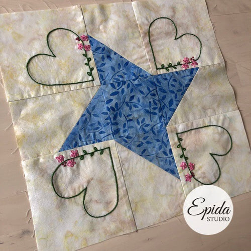 quilt block embellished with embroidery.