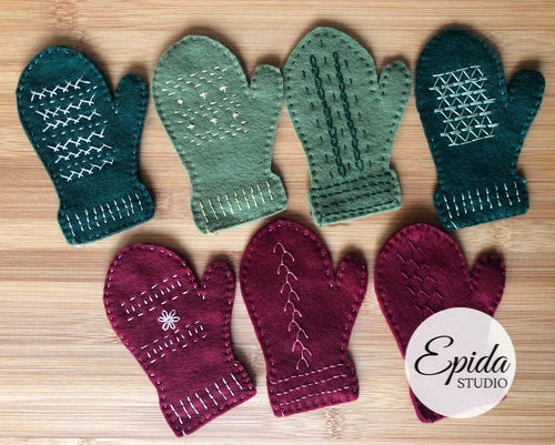 seven embroidered mitten ornaments.