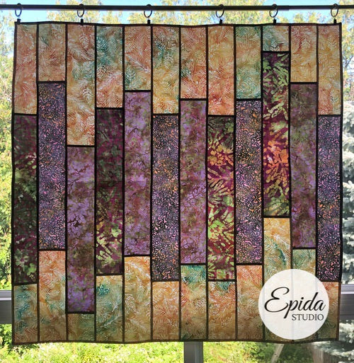 Purple and beige "Glimmer" stained glass window hanging.