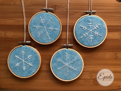 four hand-embroidered snowflakes.