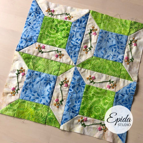 quilt block embellished with hand embroidery.