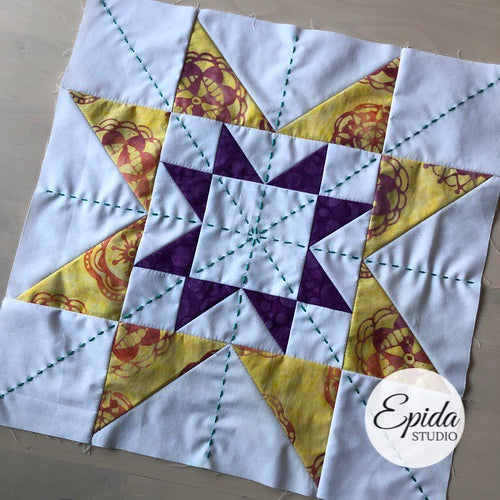 double sawtooth star quilt block embellished with hand embroidery.