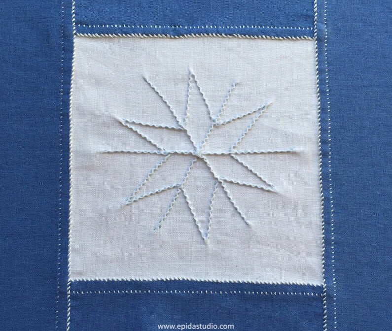close up of pointy snowflake on embroidered table runner