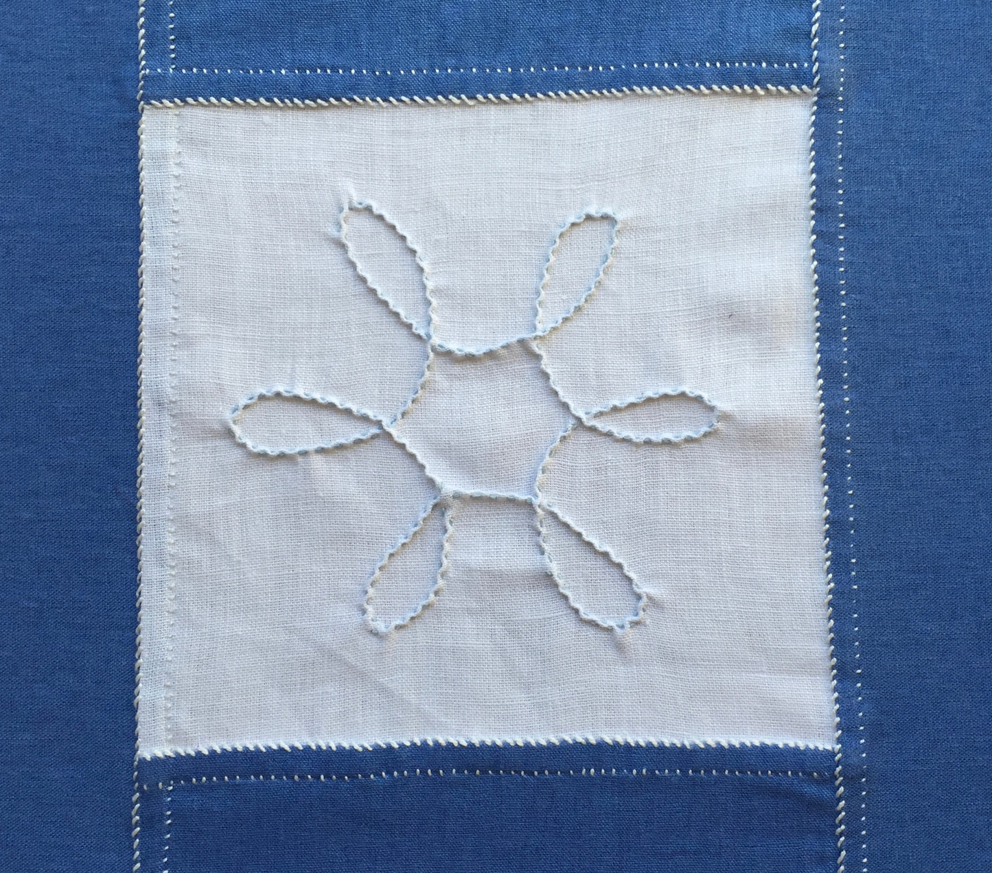 close up of looped snowflake on embroidered table runner