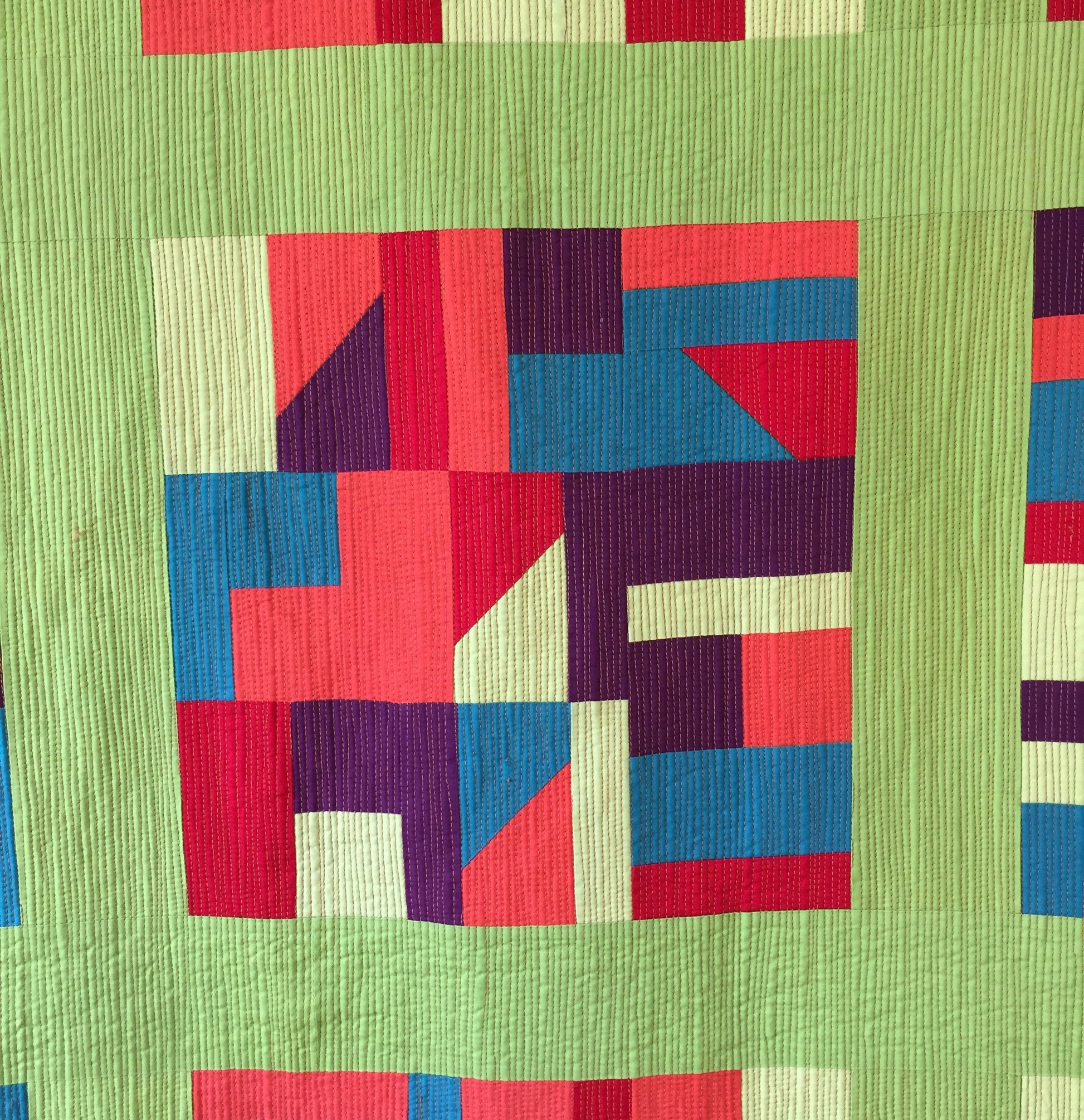 close up of quilt block in solid colours with matchstick quilting.