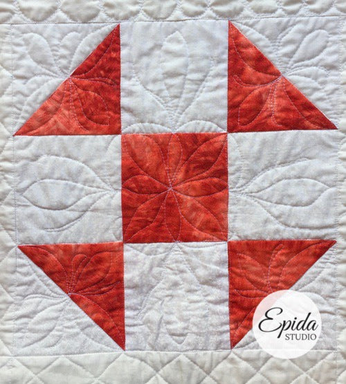 red and white shoo fly quilt block.