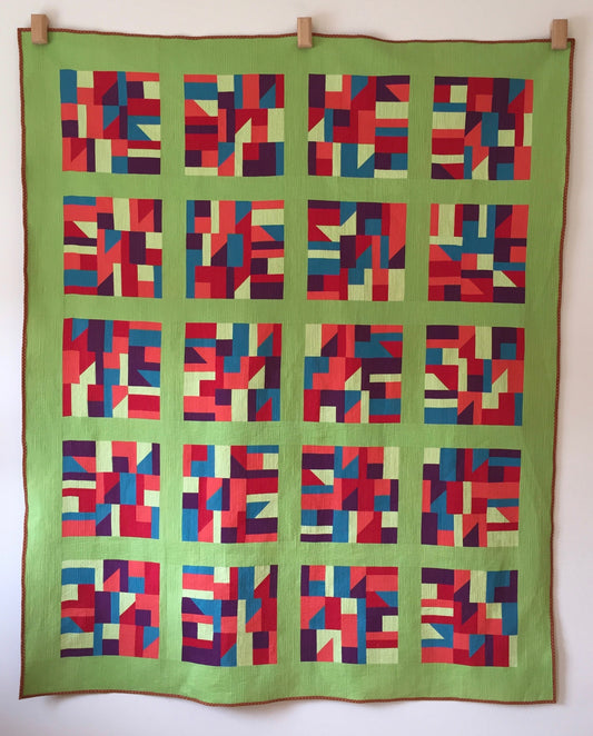 modern quilt in primary colours with lime green sashing and borders.